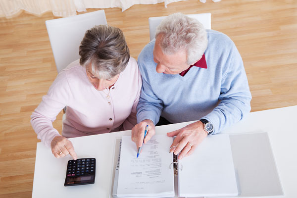 Couple reviewing estate documents created in the Edmonton law offices of Coley Hennessy Cassis with provisions for guardianship, enduring power of attorney and Personal Directive